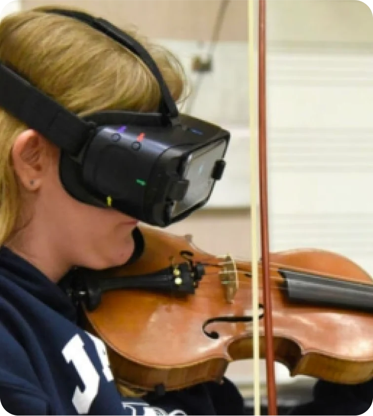 IrisVision Glasses User playing violin tablet